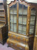 A REPRODUCTION DUTCH STYLE BURR WALNUT CABINET with Bombe chest base, the shaped top over multi-