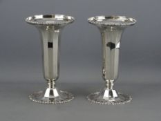 A PAIR OF FINE QUALITY SILVER VASES having pierced floral bases with panelled columns to a wide