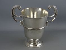 A FINE LARGE CIRCULAR BASED UNINSCRIBED SILVER TROPHY CUP with double scrolled handles, 17.2 troy