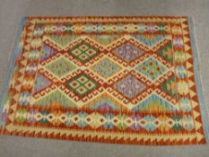 A VEGETABLE DYE WOOL CHOBI KELIM RUG, vibrant colours with multi-diamond central block pattern and