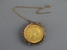 A 1911 GEORGE V GOLD SOVEREIGN in a yellow metal mount with pin