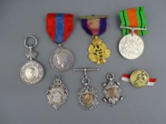 A SMALL PARCEL OF MEDALS, three silver trophy pendants, a Defence medal with ribbon and a cased
