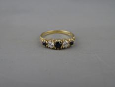 A NINE CARAT GOLD SAPPHIRE (THREE) & CZ (TWO) DRESS RING, 2 grms, size 'N'