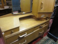 AN EARLY G-PLAN LIGHT WOOD BEDROOM SUITE of two door wardrobe, dressing table, gent's wardrobe/chest