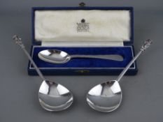 A CASED SILVER SPOON of plain form by Garrard, 1 troy oz, London 1958 and a pair of Dutch style