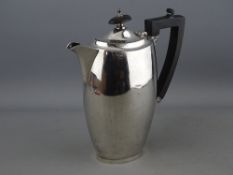 AN OVAL SILVER COFFEE POT of plain form with composition handle and knop, 12.4 troy ozs gross,