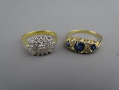 A NINE CARAT GOLD DIAMOND & SAPPHIRE DRESS RING having a centre round cut sapphire with two flanking