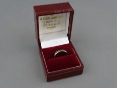 AN EIGHTEEN CARAT WHITE GOLD PLAIN WEDDING BAND, 2.3 grms, size K/L