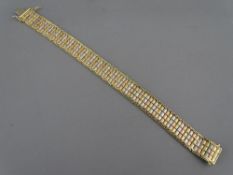 A NINE CARAT GOLD TRI-COLOUR BRACELET, 1.1 cms wide, 22 grms