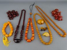 SIX AMBER COLOUR NECKLACES, a quantity of loose beads and three brooches, all untested, various