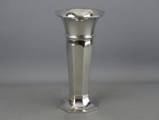 AN OCTAGONAL BASED SILVER TRUMPET VASE of slight tapered panelled form with wide neck, 7.5 troy