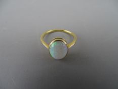 A POSSIBLY EIGHTEEN CARAT GOLD OPAL DRESS RING, 1.2 x 0.8 cms, 2.5 grms gross, size 'N/O'