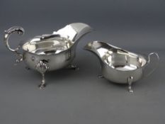 A SILVER SAUCE BOAT with scrolled handle and three shell and hoof supports, 7 troy ozs, London