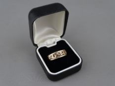 A NINE CARAT GOLD TWO COLOUR 'CARIAD' RING, 5.6 grms, size 'P'