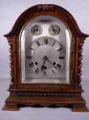 A GUSTAV BECKER DOME ENCASED BRACKET CLOCK with barley twist pillars and corner bracket feet and