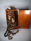 A SWIFT & SON VINTAGE BINOCULAR MICROSCOPE in a fitted mahogany case with lower drawer, lacquered