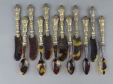 A SET OF SIX CONTINENTAL SILVER & TORTOISESHELL EFFECT KNIVES & SPOONS with embossed mask handles,