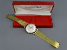 A MAPPIN & WEBB NINE CARAT GOLD CASED GENT'S WRISTWATCH with yellow metal strap in original box,