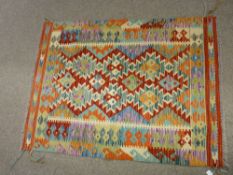 A VEGETABLE DYE WOOL CHOBI KELIM RUG, vibrant colours with zig zag central diamond block pattern and