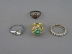 A FOURTEEN CARAT GOLD DRESS RING with centre peridot cluster, 4.5 grms, size M/N and three other