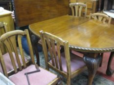 AN OVAL MAHOGANY WIND-OUT DINING TABLE with one leaf, on cabriole and ball and claw supports and six