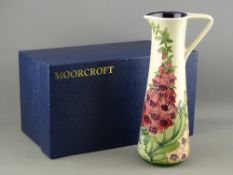 A MOORCROFT AMBERWOOD FOXGLOVE JUG designed by Rachel Bishop, 24 cms high, impressed factory marks