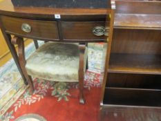 A LATE 19th/EARLY 20th CENTURY BOW FRONT MAHOGANY SIDE TABLE with two drawers having brass handles