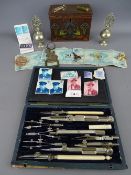 Cased draughtman's instrument set, a vintage moneybox tin with Art Nouveau design, a pair of white