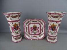 Pair of crackle glazed vases and a shallow dish, all with crested coat of arms detail, 25.5 cms high