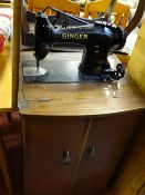 Singer sewing machine in a wooden storage/work table case