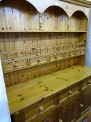 Pine dresser with five spice drawer top and the base having three drawers over three base cupboards