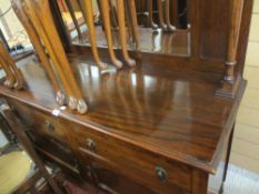 Polished mirror backed sideboard, the top having shelved pillars to a base of two drawers and two