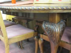 Oval mahogany wind-out dining table with one leaf, on cabriole and ball and claw supports and six (