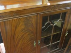 Early to mid 20th Century mahogany railback standing china cabinet having a centre glazed door