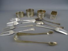 Four hallmarked silver napkin rings, a pair of sugar tongs, two teaspoons and five pastry forks, 6.5