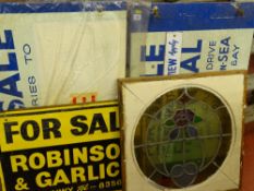 Circular stained glass window in a wooden square frame along with vintage advertising 'For Sale'