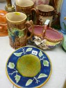 Three Victorian Majolica jugs, two plates and a floral decorated flower basket