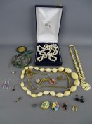 Ivory bead necklace, carved bone example, quantity of metal mounted jade type jewellery, two