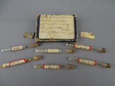 Boxed group of six glass tubes containing gold and silver solder