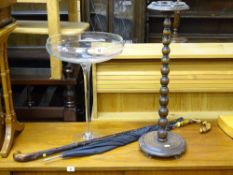 Large Babycham style decorative glass, bobbin style smoker's bow, walking stick and an umbrella