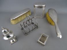 Mixed selection of hallmarked silver items including a small four section toast rack, pepper pot,
