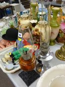 Cast iron based vintage oil lamp with glass font and funnel and a chrome plated example with funnel