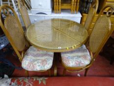 Circular Bergere glass topped table and four matching dining chairs