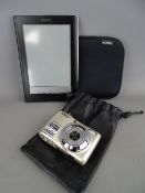 Sony digital reader in soft feel case and a Nikon digital camera with pouch (no chargers)