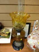 Brass column oil lamp with amber glass reservoir and etched glass shade