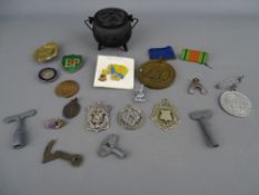 Irish bog oak cauldron with lid with a selection of silver and other fobs and badges etc including
