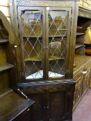 Standing corner cupboard with upper twin glazed doors over base carved doors