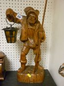 Excellent carved figure of a Continental gentleman holding a spear and lamp