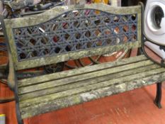 Wooden garden bench with cast metal ends and latticed back