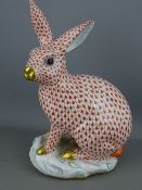 Herend Hungary hand painted porcelain figure of a rabbit seated on his haunches upon a rocky base,